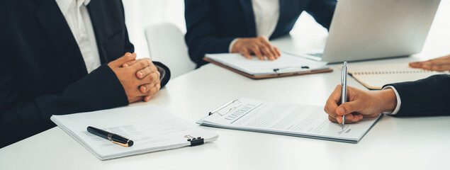 Two business executive in boardroom discuss term and company merging agreement, review corporate...
