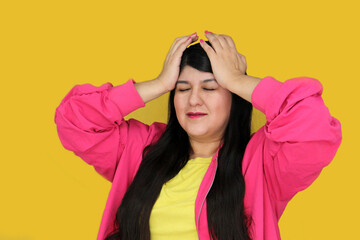 30 year old Latina woman suffers from headache or migraine due to stress and lack of sleep