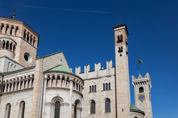 View of Trento Cathedral in a beautiful blue sky sunny day. Clock Tower (Torre Civica or Torre di...