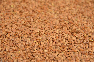 Flax seeds (linseeds) background, closeup, top view