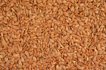 Flax seeds (linseeds) background, closeup, top view