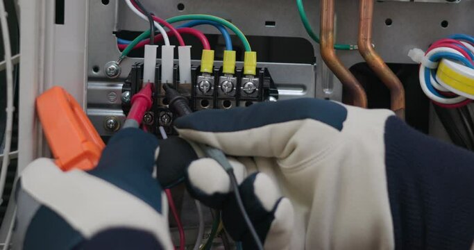 Air conditioner technician hand check condenser circuit by amp clamp meter,Air conditioner maintenance service, Home service concept