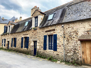 Fototapeta na wymiar A well preserved old 17th century stone row house with slate roof on Rue du Plessis in the center of Redon, France. Part of the city’s rich architectural heritage as an important town in Brittany.