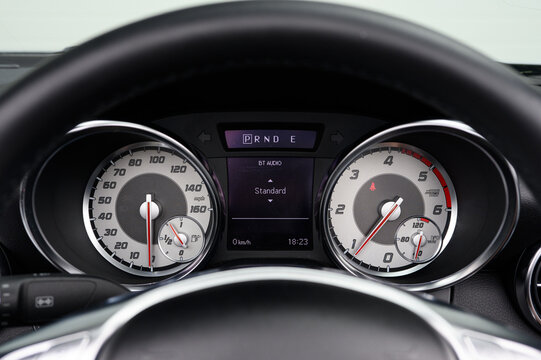 The dashboard of a car shows the speedometer and a digital readout of the car's standard deviation