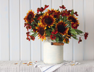 sunflowers in a can on a table on a white board background.