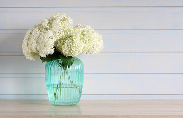 White Hydrangeas In Glass Vase On The Table In Cottage. Copy space. Bouquet Of Garden Flowers.