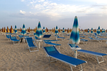 Empty deck chairs in early morning at Rivazzurra, Rimini Italy - obrazy, fototapety, plakaty