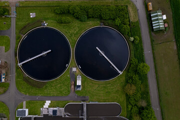 Circular sewerage water treatment containers facility in The Netherlands seen from above. Aerial...