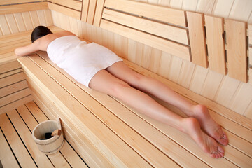 Young woman relaxing in sauna, top view. Spa treatment concept - 790396301