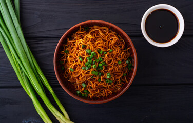 Fried Instant noodles with  green onion and soy sauce , traditional asian food