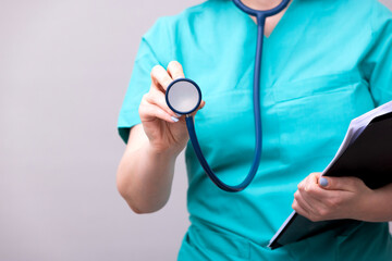 Female doctor holds stethoscope in hands closeup 