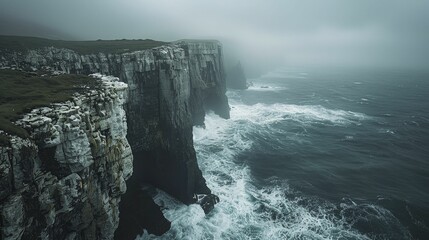 Experience the intense ambiance of a stormy sea from a dramatic clifftop, highlighting vast space and emotive minimalism. - obrazy, fototapety, plakaty