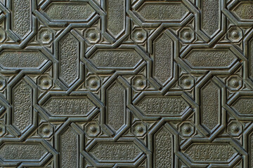 Islamic patterns and Arabic calligraphy of the Seville Cathedral door, Spain. - 790411584
