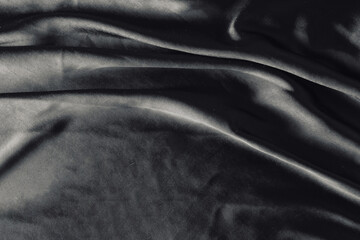 Smooth elegant dark black satin texture can use as abstract background. Luxurious background design
