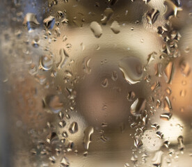 Gold background with water drops and light reflections. Square picture- Copy space