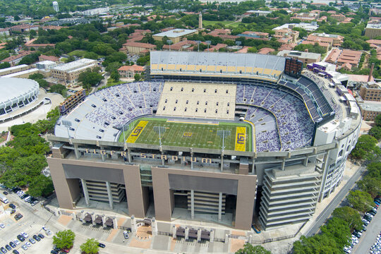aerial shot of Tiger Stadium with red brick buildings and lush green trees on the campus of Louisiana State University in Baton Rouge Louisiana USA