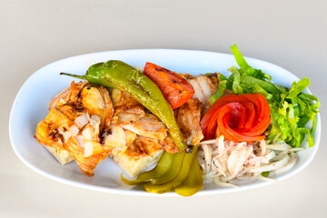 Turkish and Arabic Traditional Ramadan doner kebab with tasty tomato sauce and rice or turkish pilav in white plate on wood table background. ( Pilav ustu doner). Ekmek arasi doner, doner durum. 