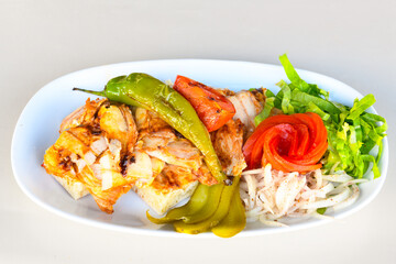 Turkish and Arabic Traditional Ramadan doner kebab with tasty tomato sauce and rice or turkish pilav in white plate on wood table background. ( Pilav ustu doner). Ekmek arasi doner, doner durum. 