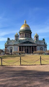 St. Isaac's Cathedral, Russia. Spring view of St. Petersburg, the cultural center of the city. Sunlit views of the sculptures of angels on the colonnade of St. Peter's Cathedral. St. Isaac's Cathedral