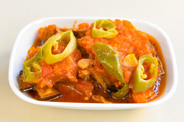 Turkish and Arabic Traditional Ramadan doner kebab with tasty tomato sauce and rice or turkish pilav in white plate on wood table background. ( Pilav ustu doner). Ekmek arasi doner, doner durum. 