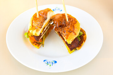 Big tasty burger with beef cutlet on a plate. Crispy chicken burger.