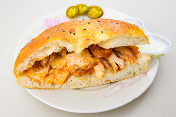 Turkish and Arabic Traditional Ramadan doner kebab with tasty tomato sauce and rice or turkish pilav in white plate on wood table background. ( Pilav ustu doner). Ekmek arasi doner, doner durum. 