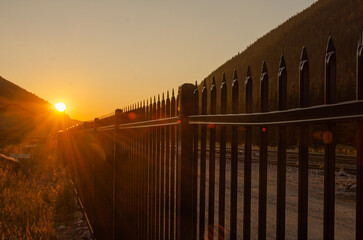 sunrise over a fence