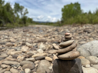 a stacked cairn of rocks in a riverbed