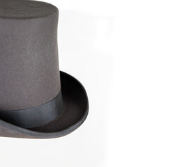 Magic hat. Topper. Elegant vintage gray beige wool felt top hat with black band. Grosgrain ribbon trim around rolled brim. Isolated on white background. Close-up. Copy space. Cut out. Clipping path.
