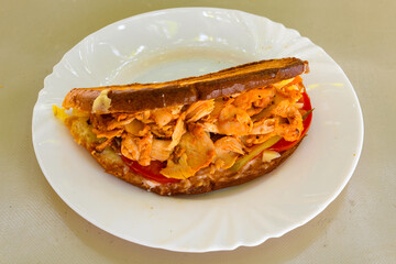 Turkish and Arabic Traditional Ramadan doner kebab with tasty tomato sauce and rice or turkish pilav in white plate on wood table background. ( Pilav ustu doner). Ekmek arasi doner, doner durum. 