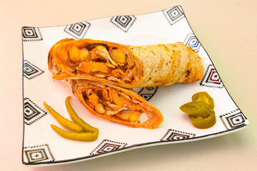 Turkish and Arabic Traditional Ramadan doner kebab with tasty tomato sauce and rice or turkish pilav in white plate on wood table background. ( Pilav ustu doner). Ekmek arasi doner, doner durum. 
