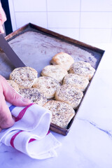 Jewish baker takes out freshly Pletzalej baked loaves from steel pan - obrazy, fototapety, plakaty
