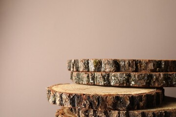 Presentation for product. Wooden stumps on beige background. Space for text