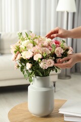 Woman with beautiful bouquet of fresh flowers at home, closeup