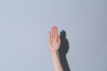 Woman showing open on light grey background, closeup