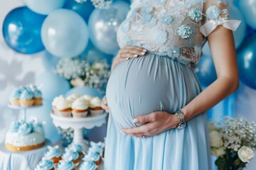 Pregnant girl expecting a boy holds her belly at a baby shower gender reveal party. Celebration of motherhood, the birth of a boy, cakes, cupcakes, decorations - 790447983