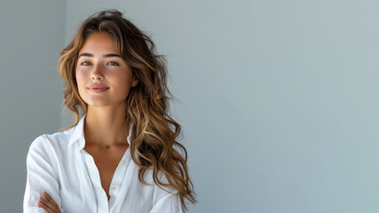Latin business woman in white shirt smiling looking up towards copy space
