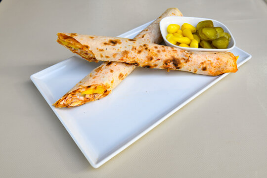 Lavash doner kebab ( zurna et tavuk doner durum )  or shawarma sliced in plate isolated. 