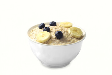 oatmeal porridge breakfast  with banana slice,blueberry in bowl  in white background