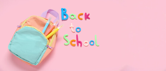 Text BACK TO SCHOOL, backpack and markers on pink background