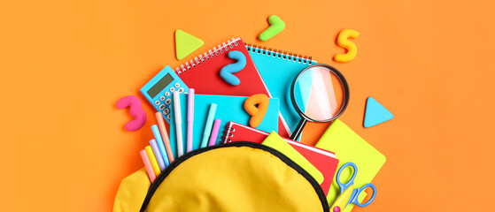 Stylish school backpack and different stationery on orange background