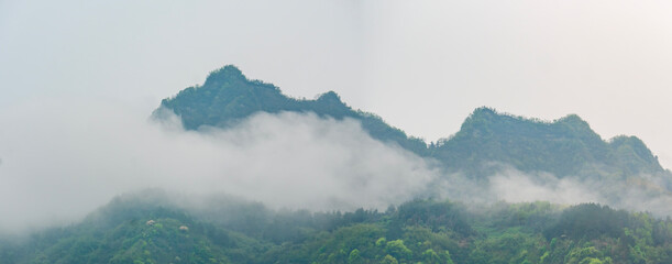mountain landscape with fog. Towering mountain peaks atop hills in the Mount zhangjiajie ...