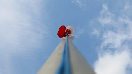 Red and white flag at the end of the pole