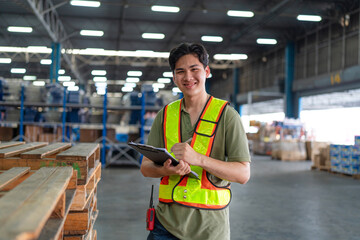 Portrait of male staff with holding clipboard working in warehouse, Industrial and industrial...