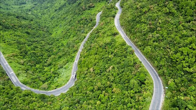 Winding road - Lovcensky serpentine with dangerous turns that leads to the top of the Montenegrin mountains covered with vegetation