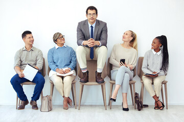 Businessman, people and waiting room with group for interview, career or job at office. Young man...