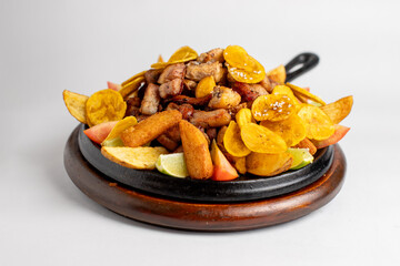 A plate of food with a variety of ingredients including bananas, potatoes