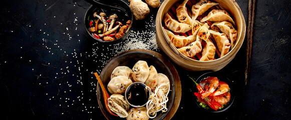 Chinese dumplings, soy sauce, mushrooms on dark background. traditional asian food concept