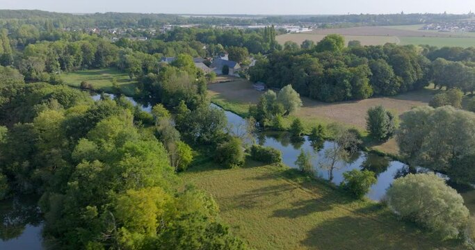 An Aerial Snapshot Reveals A Small Hamlet Gracefully Poised By The Riverside, Its Rural Charm Accentuated By The Surrounding Tapestry Of Trees And Waterways. - Chateaudun, France