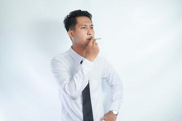 young handsome businessman smoking a cigarette